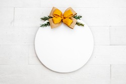 Blank white round wood sign on white backgound with yellow bow, fall door decor mockup 