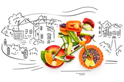 Healthy food concept of a cyclist riding a bike made of fresh vegetables and fruits, on sketchy background. 