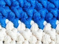 Close up of half double crochets white and blue  textile. Basic crotchet stiches. Can be used as a background.