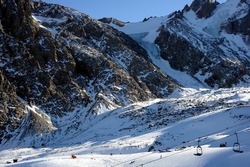 Ski resort, cable car (aerial lift) among snow-covered mountain peaks (over 3000 meters). Ile Alatau, also spelt as Trans-Ili Alatau, etc., is a part of the Northern Tian Shan mountain system