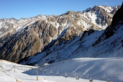 Ski resort, cable car (aerial lift) among snow-covered mountain peaks (over 3000 meters). Ile Alatau, also spelt as Trans-Ili Alatau, etc., is a part of the Northern Tian Shan mountain system