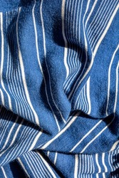 Blue Striped Background .Soft fabric with white and blue stripes .White and blue striped fabric texture with creased folds .