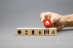 Fire prevention, Cube wooden toy block stack with prevent icon with door exit sing or fire escape with fire extinguisher and emergency protection symbol for safety and rescue in the building.