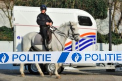 Politie / police tape in front of Belgian mounted police officer and horse trailer in Belgium 