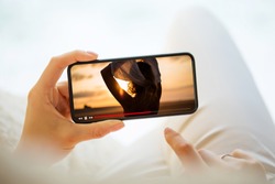 Woman watching video on mobile phone