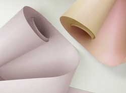 two rolls of flexible fabric. pink and light purple on a white background. fabric samples with fibrous texture. banner material, digital printing industry