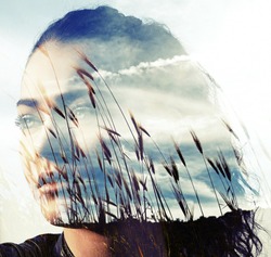 Double exposure of girl with gorgeous eyes and wheat field