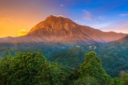 Beautiful Mount Kinabalu at sunset from Nabalu Town, North Borneo, Sabah, Malaysia. Soft Focus and noise visible due to long exposure shot. 
