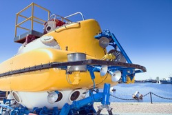 Large yellow rescue bathyscaphe with illuminators and mechanical manipulators