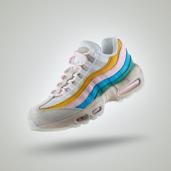 
White sneaker with a diversity of colors, shoe on a white gradient background, Yellow, pink, blue, green