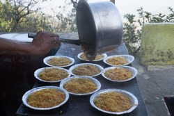 Plates of hot steam instant noodles, maggi, snacks, sevai being served at a hill station, picnic spot, vacation, holidays, trip, street, road in autumn, fall, winter, rain, monsoon by vendor. Tourism