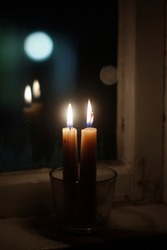 Two candles on windowsill