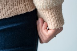 Pilled sweater. Closeup woman wearing a old used sweater with lint (pilling). 