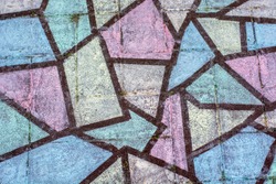 Chalk drawings are popping up on sidewalks in the neighborhood during coronavirus covid-19 pandemic. A beautiful colorful geometrical mosaic chalk drawing from above. 