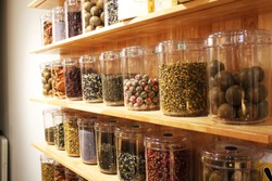 Natural herbal medicine sets selected in a variety of jars The background on the wooden cabinet Arranged in an orderly way
