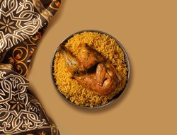 Chicken kabsa - homemade arabian rice, Saudi food. 
The national Saudi Arabian dish chicken kabsa with roasted chicken quarter and almonds