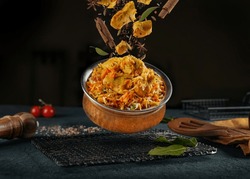 indian chicken biryani, Spicy chicken biryani food photography, flying food, black background.