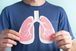 Man holding lungs decorative model. World tuberculosis TB day, pneumonia, respiratory diseases concept. Closeup