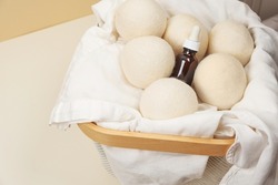 Wool Dryer Balls On Textile Cloth With Oil Aroma Battle In Basket. Eco Friendly Laundry Supplies. Alternative Drying Of Linen. Flat Lay. 