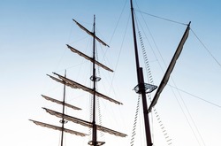 Pirate ship mast on blue sky background