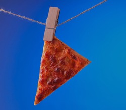 Flatbread,Pizza hanging on a washing line with a blue sky background.