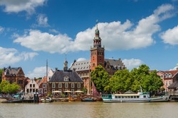 Leer, Germany. Panoramic view from Leda river on city hall, old weigh house in dutch classical baroque style, tourist harbor and bridge