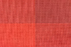 Mesh structure of finely cellular plastic fabric. Red square pattern.