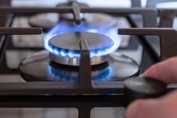 A burning gas burner on the kitchen stove. The use of natural gas for cooking.