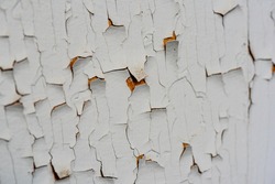 Cracked flaking white paint, background texture