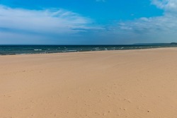 Pristine white sandy beach on a sunny day with blue sky