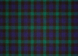 A sample of wool suit fabric tartan. Checkered background with a close-up image of textiles. 