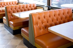 A view of several vintage restaurant banquette style bench seating in a local burger restaurant in Los Angeles, California.