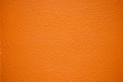 Saturated intensive orange textured surface.