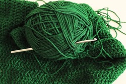 emerald green cotton ball an d crochet needle