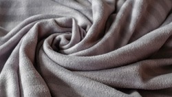 Warm blanket in gray circular shape.
