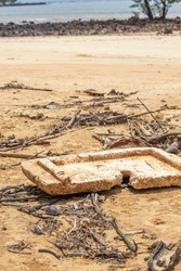 EPS foam - polystyrene board polluting the environment on a beach