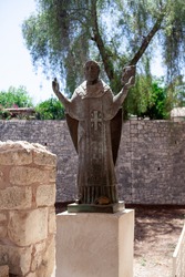 Statue of San Nicholas near famous church of Saint Nicholas. Old antique monument. Christian saint.