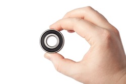 Ball bearing isolated. Male hand holding metal roller bearing. Super Precision Ball Bearings used in high performance machinery.
