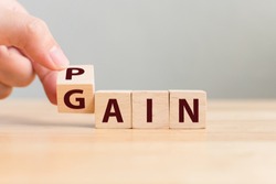 Pain or Gain concept, Hand flip wood cube change the word