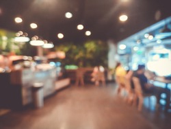 Blurred images of the coffee shop cafe interior background and lighting bokeh