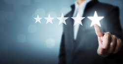 Businessman pointing five star symbol to increase rating of company