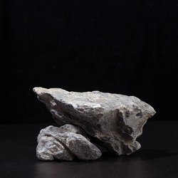 Stone podium for packaging and cosmetic presentation on black background, square.