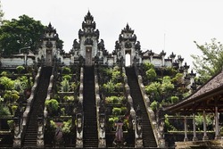 Majestic balinese culture Lempuyang temple in Bali - high stairs and sacred gate with towers decorated statues carved of stone and lush garden. Famous landmark of hindu, balinese, buddhism religion.