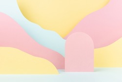 Elegant fashion style paper abstract stage mockup with pink arch podium, pastel mountain landscape - yellow, mint color slopes. Template for advertising, presentation cosmetic produce, showcase.