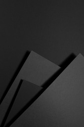 Dark grey carbon textured abstract geometric background with soar stepped rectangle surfaces, angles, black shadow lines in graphic minimal monochrome business style, top view, copy space, vertical.