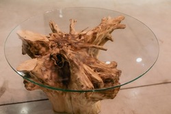 Handmade wood table made of the dry root of the tree and round glass table top. Tree root furniture