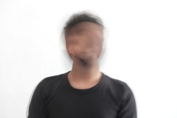 blurry movement of man in white background, blurred face of man wearing black t shirt, slow shutter speed portrait