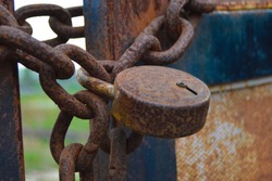 Rust  iron gate locked with iron chain and lock