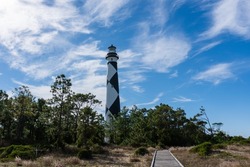 A wooden path leads beside the Cape Lookout lighthouse in the Outer Banks of North Carolina; landscape