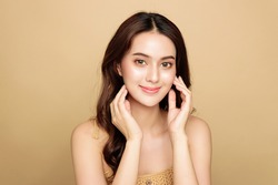 Asian woman are happy with perfect clean healthy skin and beautiful long brown hair. Cute female model clean fresh skin . Expressive facial expressions. Cosmetology concept.